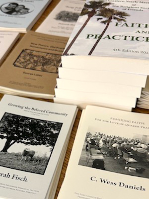 MENU-Publications-About Two sets of hands holding a small plant sprout in soil